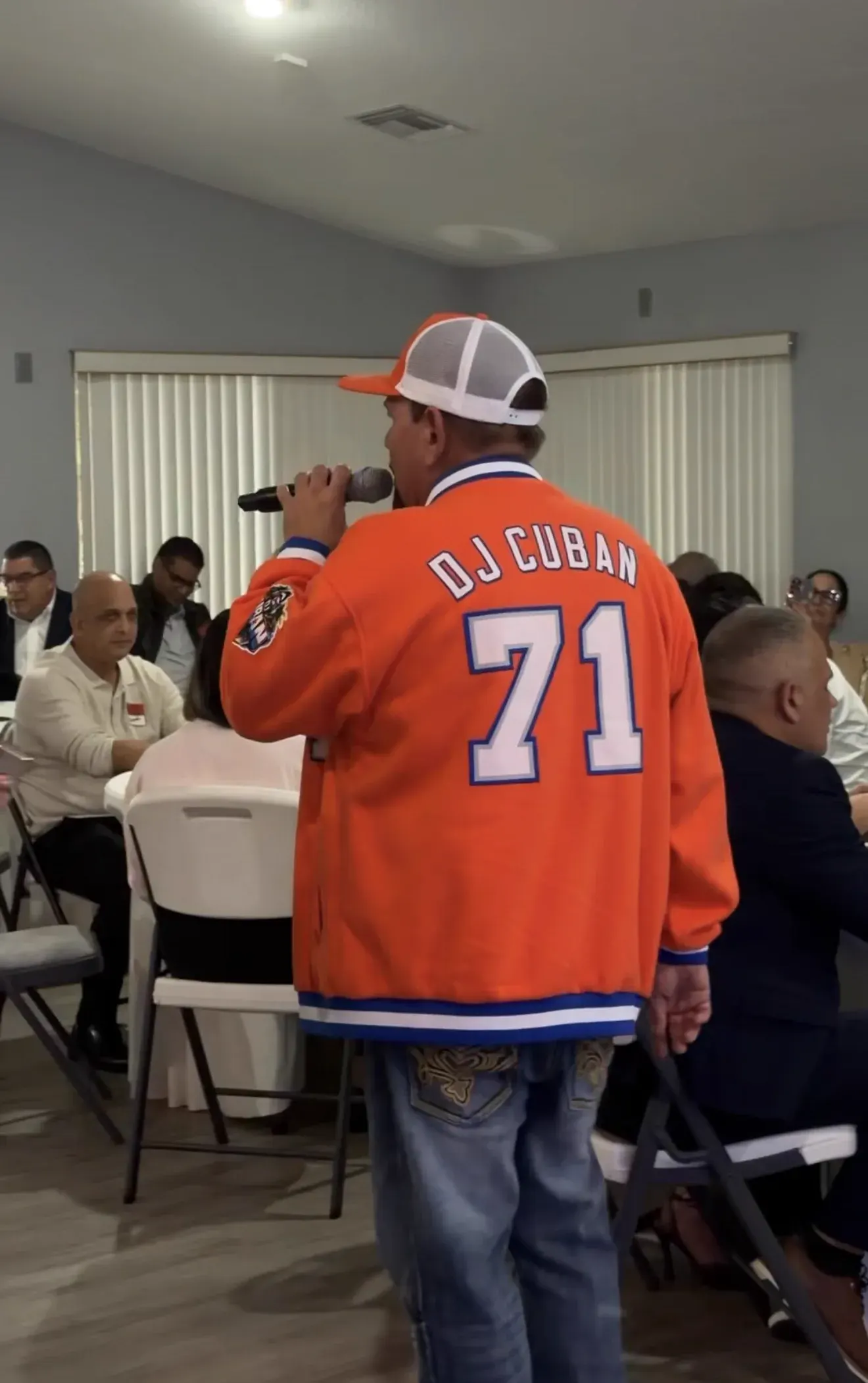 DJ Cuban singing to seated guests